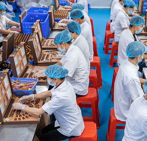 Workers are packaging finished skin care products