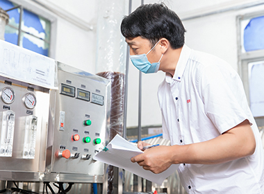 A worker is checking water purification devices